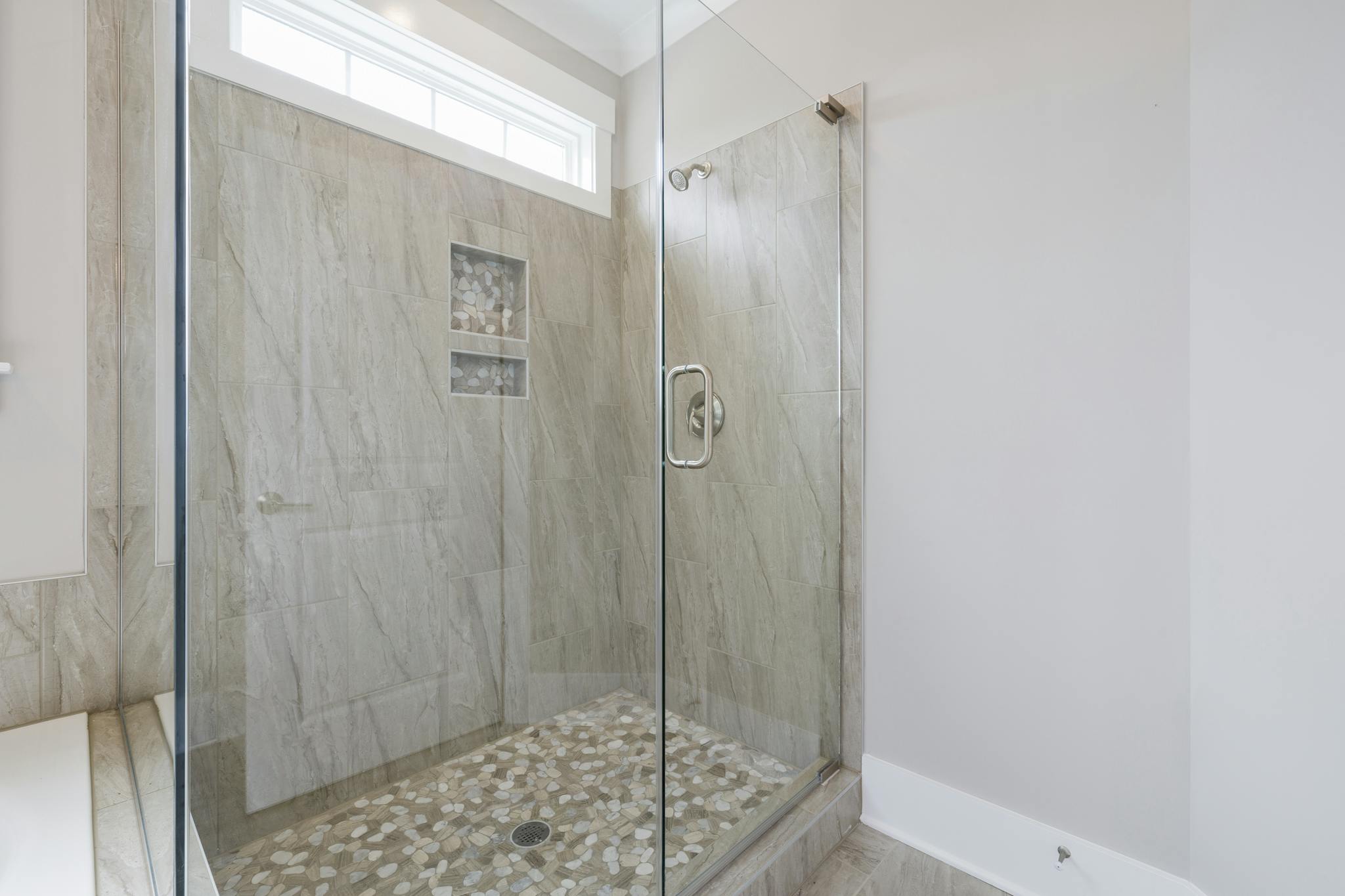 Spacious luxury bathroom remodel featuring a contemporary marble shower with glass doors, combining elegance and modern design in San Antonio, TX by Simplicity Home Pros